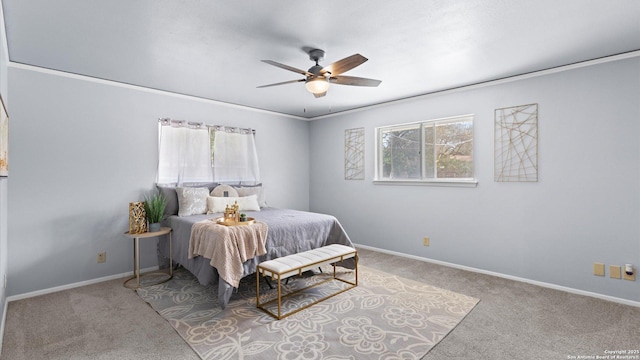 carpeted bedroom with a ceiling fan and baseboards