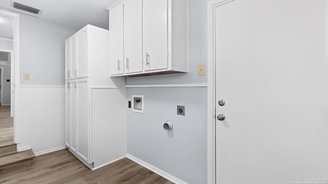 clothes washing area featuring visible vents, wood finished floors, cabinet space, hookup for an electric dryer, and hookup for a washing machine