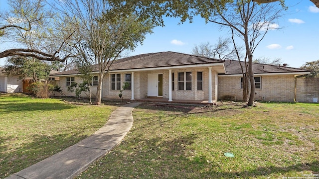 view of front of house with a front lawn, covered porch, and brick siding