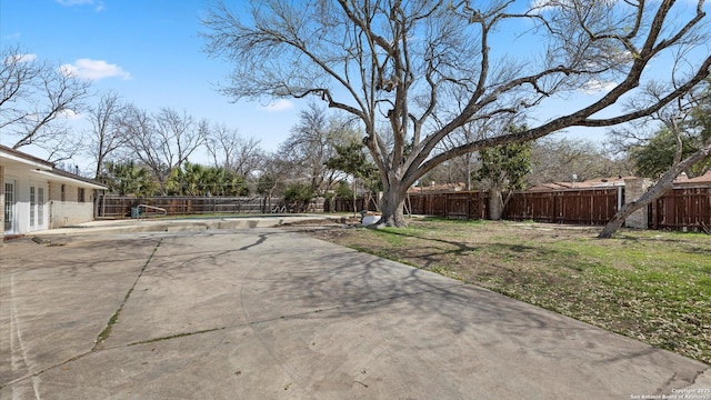 view of yard featuring a patio and a fenced backyard