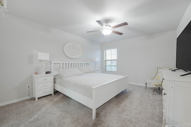 bedroom with ceiling fan, baseboards, and light carpet