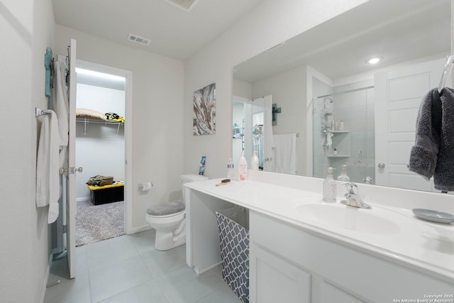 full bathroom featuring vanity, visible vents, tiled shower, tile patterned floors, and toilet