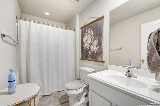 bathroom featuring a shower with curtain, toilet, and vanity