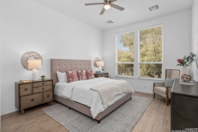 bedroom with light wood-style flooring, baseboards, and visible vents