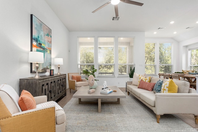 living area with visible vents, lofted ceiling, recessed lighting, wood finished floors, and a ceiling fan