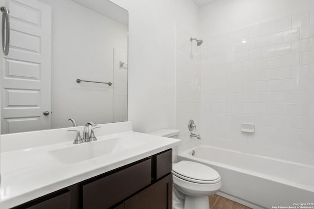 full bath with bathtub / shower combination, wood finished floors, toilet, and vanity