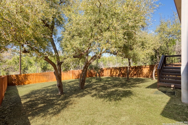 view of yard featuring stairway and a fenced backyard