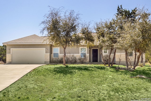 view of front facade with a front yard, a garage, driveway, and stucco siding