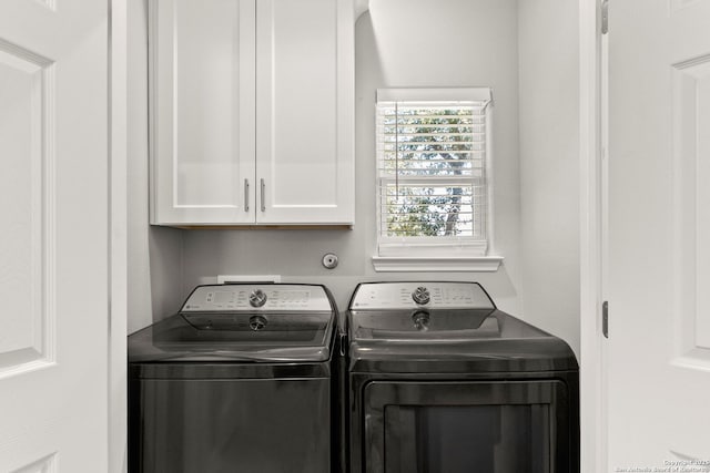 laundry room with cabinet space and washing machine and dryer