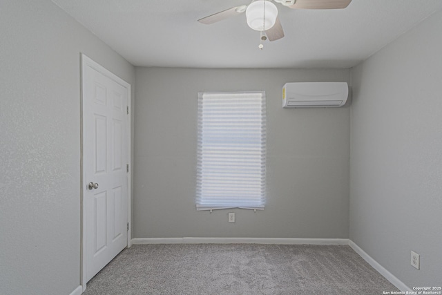 spare room with baseboards, carpet, a ceiling fan, and a wall mounted AC