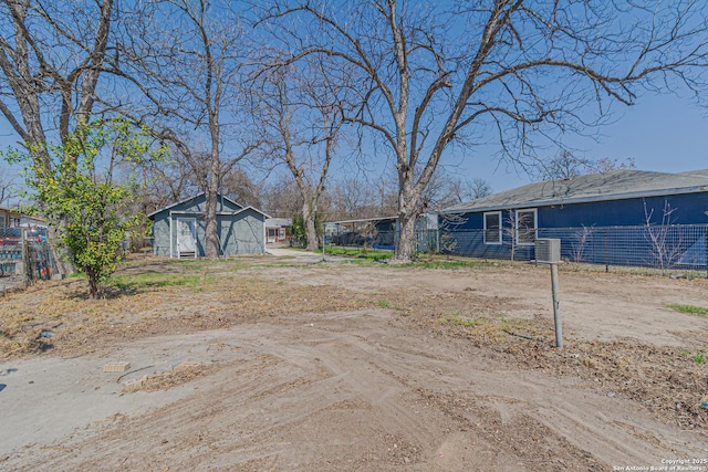 view of yard with an outbuilding, cooling unit, and fence