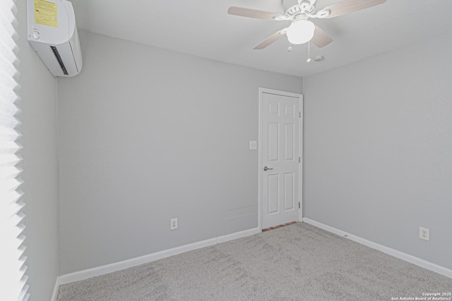 carpeted empty room with ceiling fan, an AC wall unit, and baseboards