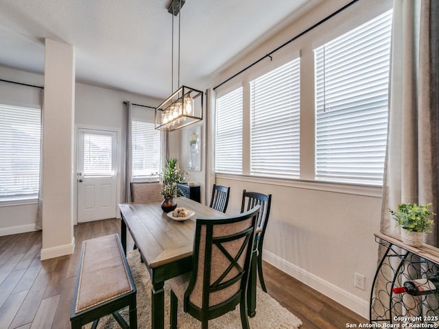 dining space with dark wood-style floors and baseboards