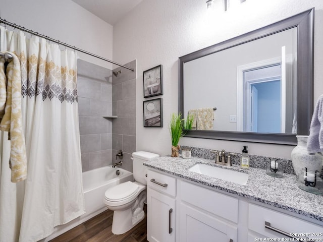 full bath featuring toilet, wood finished floors, vanity, and shower / bath combination with curtain