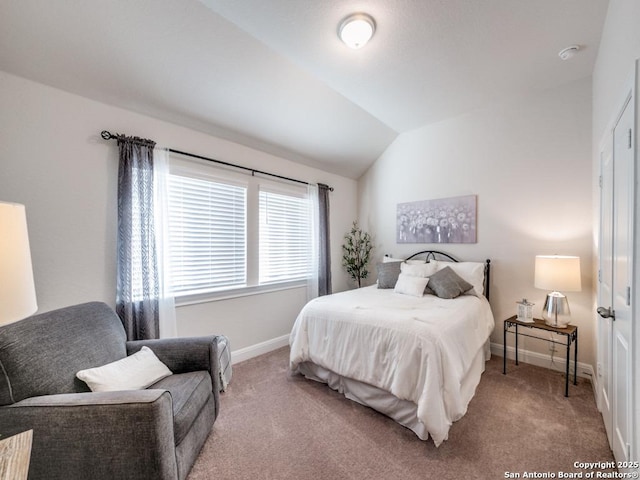 carpeted bedroom with baseboards and lofted ceiling