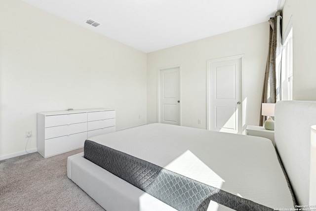 bedroom featuring baseboards, visible vents, and carpet floors