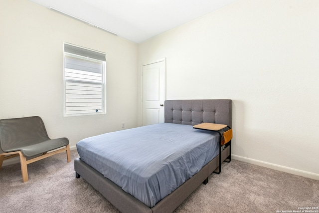 bedroom with baseboards and carpet flooring