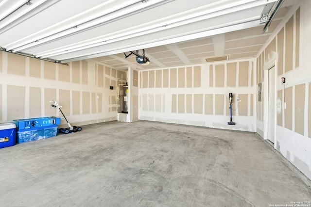 garage featuring a garage door opener and water heater