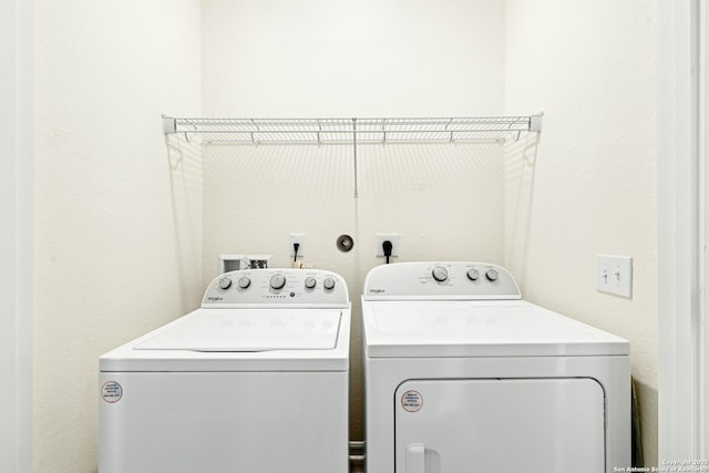 clothes washing area with washing machine and clothes dryer