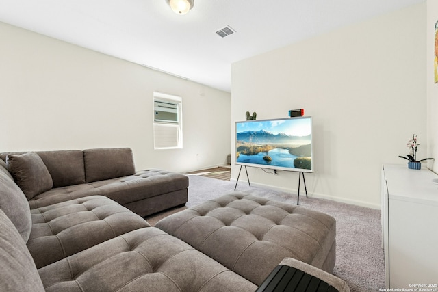 carpeted living area with baseboards and visible vents