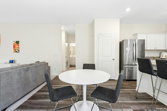 dining area featuring recessed lighting, baseboards, and wood finished floors