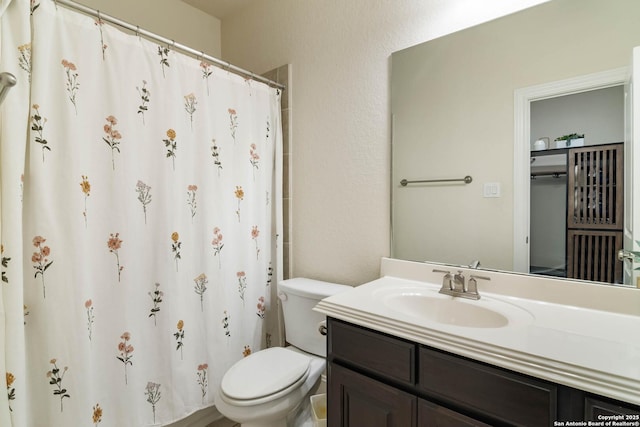 full bath with vanity, a shower with shower curtain, toilet, and a textured wall