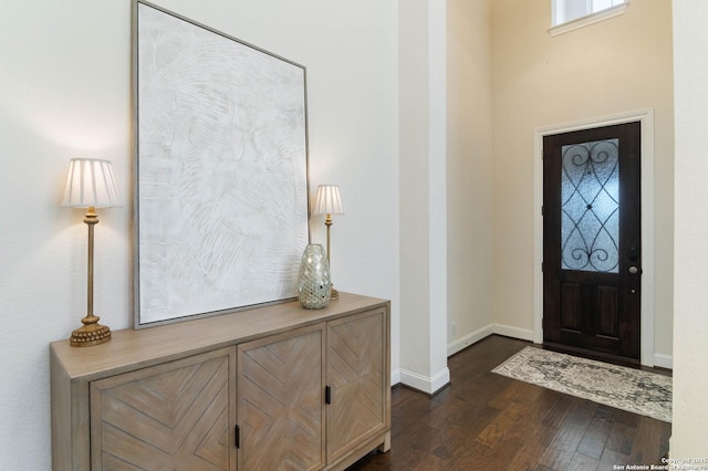 foyer with baseboards and dark wood finished floors