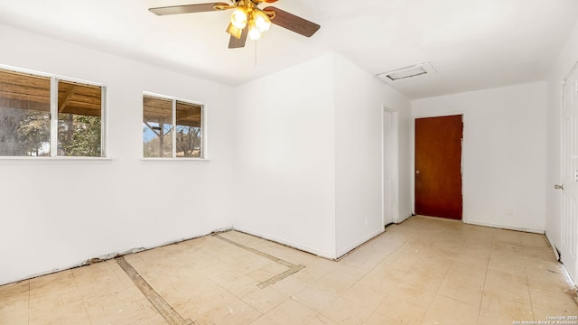 unfurnished room with tile patterned floors, a ceiling fan, and visible vents