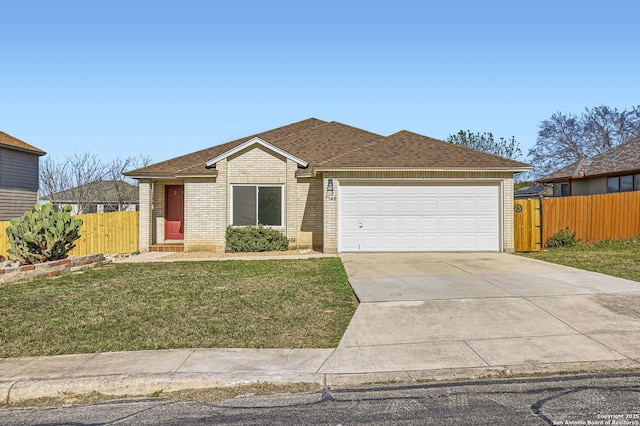 view of front facade featuring brick siding, fence, a front yard, a garage, and driveway