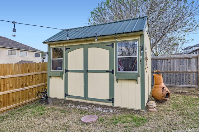 view of shed with a fenced backyard