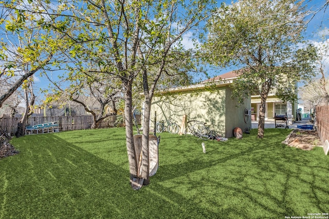 view of yard with a fenced backyard