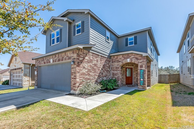 traditional-style home featuring brick siding, fence, concrete driveway, a front yard, and an attached garage