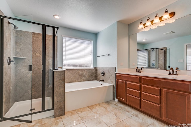 bathroom with visible vents, a stall shower, a sink, double vanity, and a bath