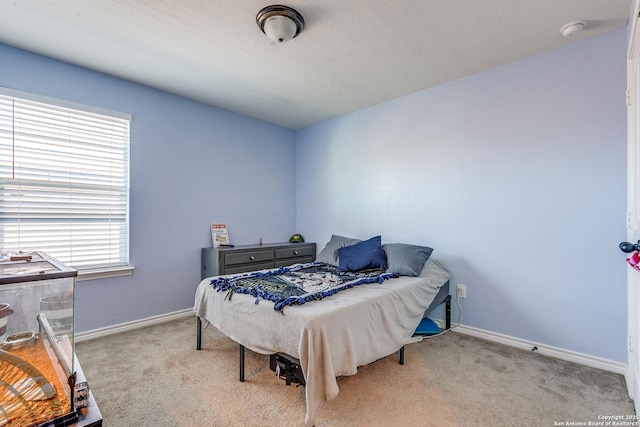 carpeted bedroom featuring baseboards