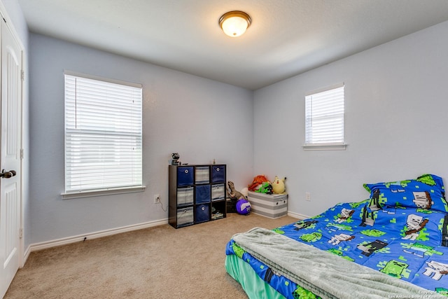 bedroom with carpet flooring and baseboards