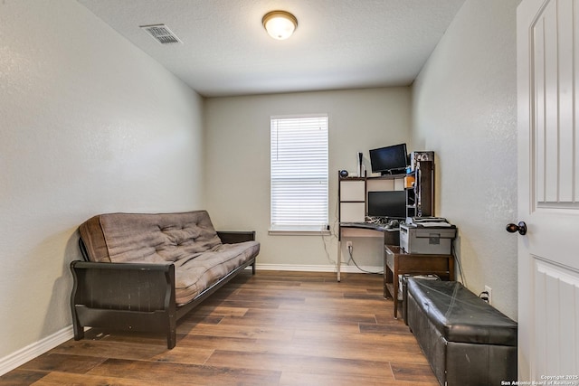 office with visible vents, baseboards, and wood finished floors