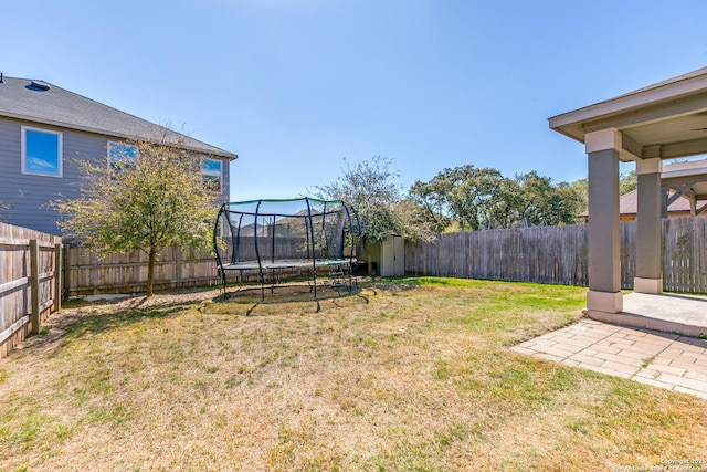 view of yard featuring a fenced backyard and a trampoline