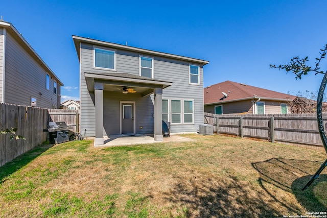 rear view of house featuring a fenced backyard, a patio area, a lawn, and ceiling fan