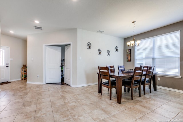 dining space featuring baseboards, visible vents, plenty of natural light, and an inviting chandelier