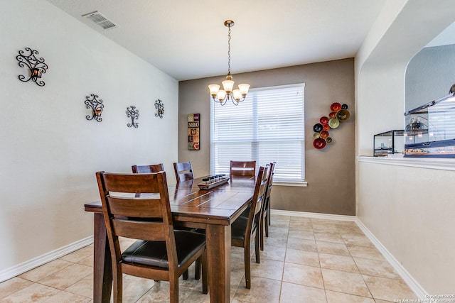 dining room with light tile patterned floors, visible vents, baseboards, and an inviting chandelier