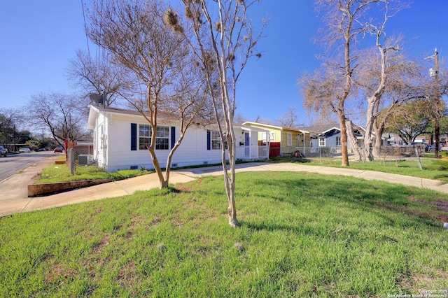 ranch-style home with crawl space, concrete driveway, a front yard, and fence