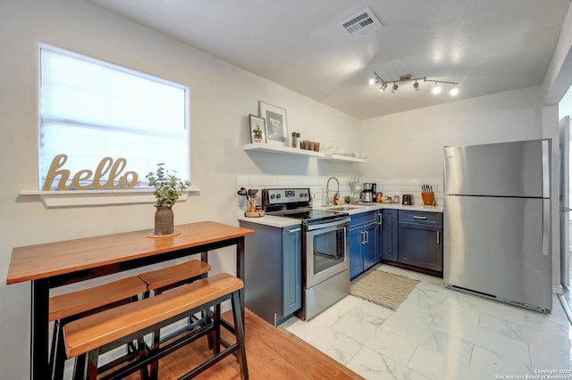 kitchen featuring a sink, blue cabinetry, marble finish floor, stainless steel appliances, and open shelves