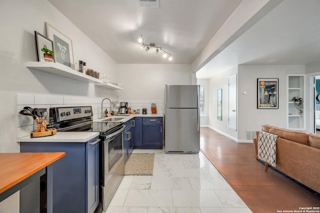 kitchen with a sink, marble finish floor, stainless steel appliances, blue cabinets, and open shelves