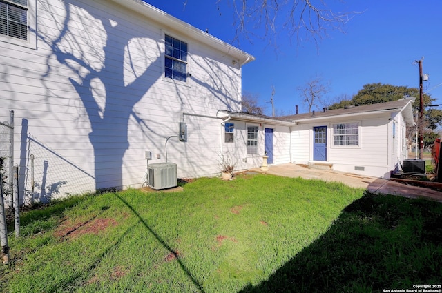 back of house featuring crawl space, central air condition unit, a yard, and entry steps