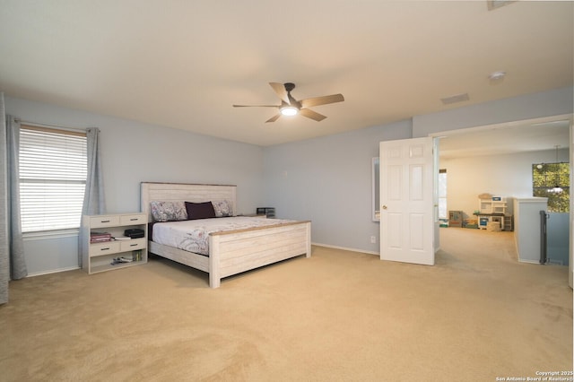 bedroom featuring visible vents, baseboards, light colored carpet, and ceiling fan