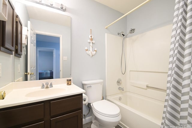 bathroom featuring toilet, shower / bath combo, and vanity