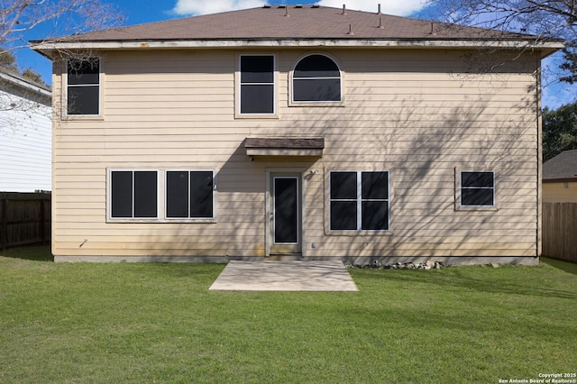 back of property featuring a lawn, a fenced backyard, and a patio area