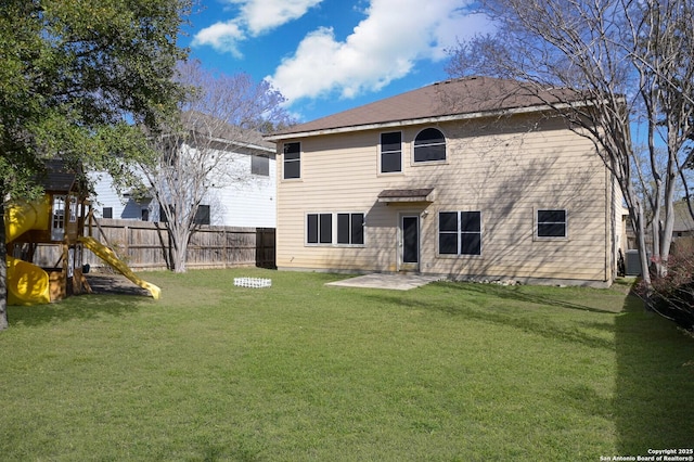 rear view of property with a playground, fence, central air condition unit, a lawn, and a patio