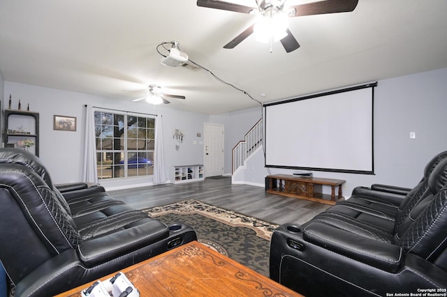 cinema room with a ceiling fan and wood finished floors