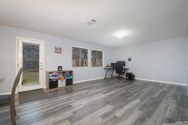 unfurnished office featuring visible vents, baseboards, and wood finished floors